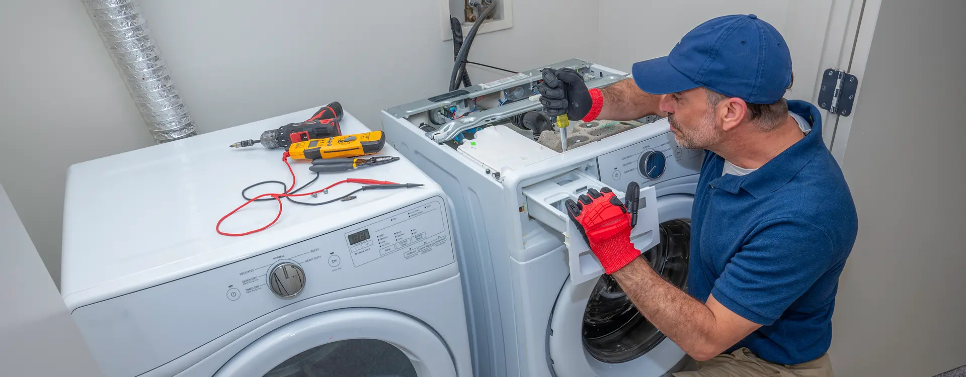 Repairman fixing a washing machine.